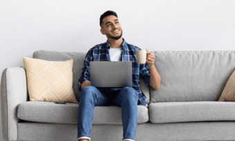 Happy man using internet at home