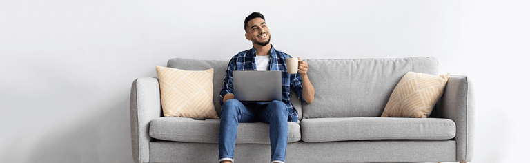 Happy man using internet at home