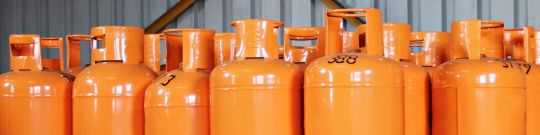 Orange LPG gas cylinders lined up