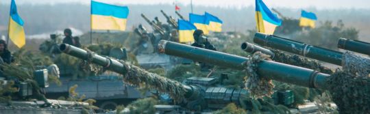 Row of tanks with Ukrainian flags flying