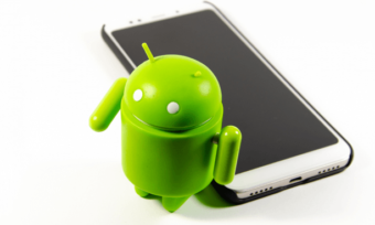 Green Android mascot next to smartphone