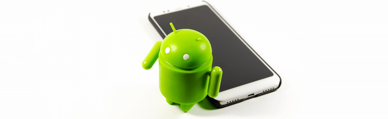 Green Android mascot next to smartphone
