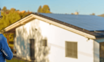 Man and his daughter looking at rooftop solar on a house.