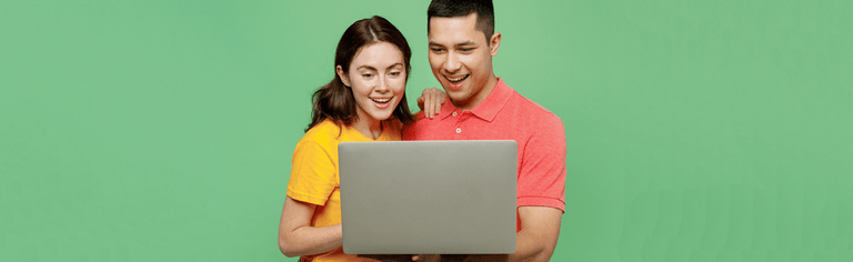 young couple happy using laptop with green background