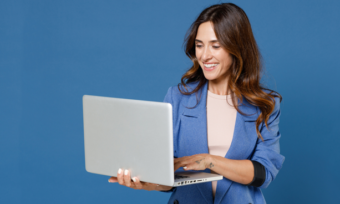 woman using laptop with blue background