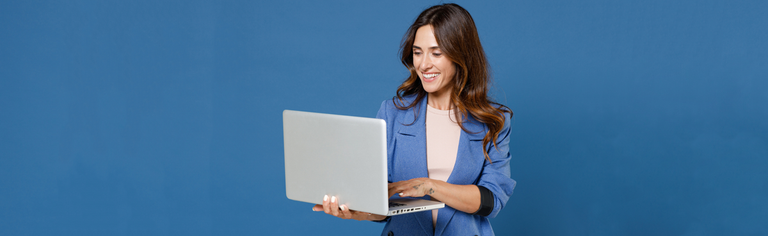 woman using laptop with blue background