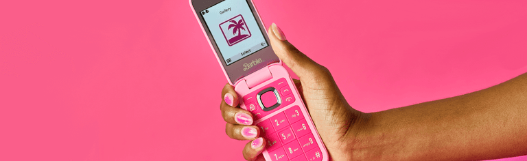 Pink Barbie Flip Phone in woman's hand